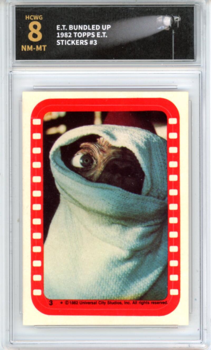 1982 Topps E.T. Stickers #3 E.T. bundled up - Graded HCWG 8  Image 1